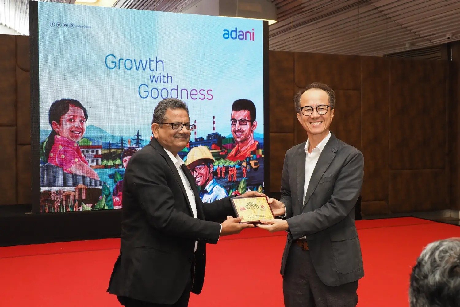 Group of men posing with large cartoon character inflatable figures at night outdoors