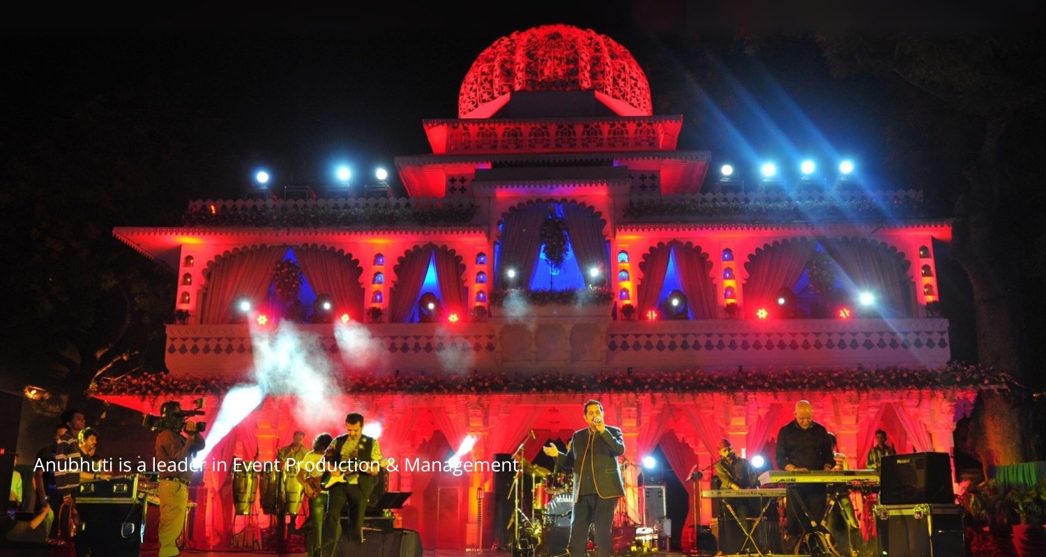Elegant wedding setup with floral decorations and seating, white chairs and pastel flowers on tables, soft natural lighting, wide angle with guests seating