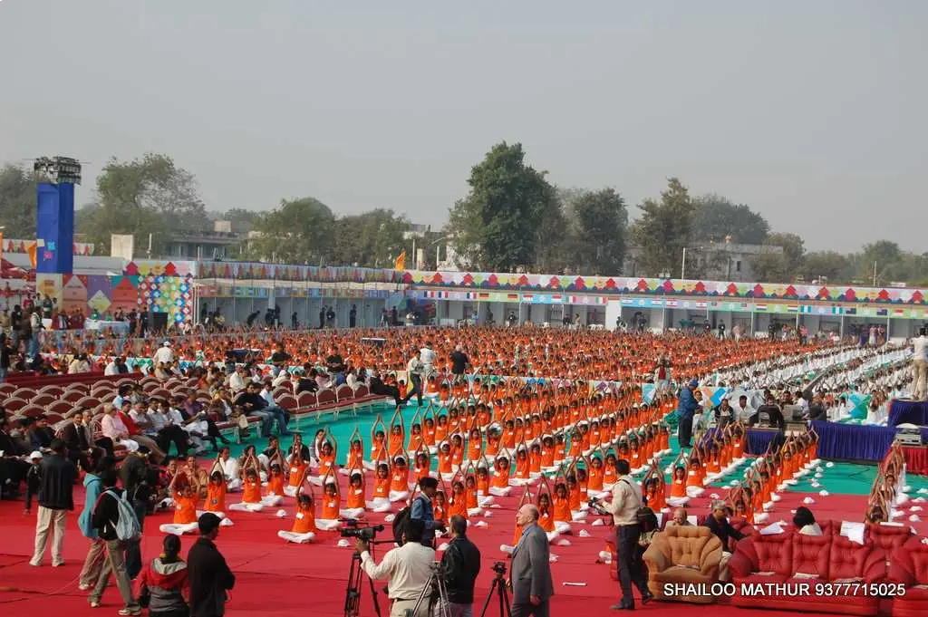 Group of men posing with large cartoon character inflatable figures at night outdoors