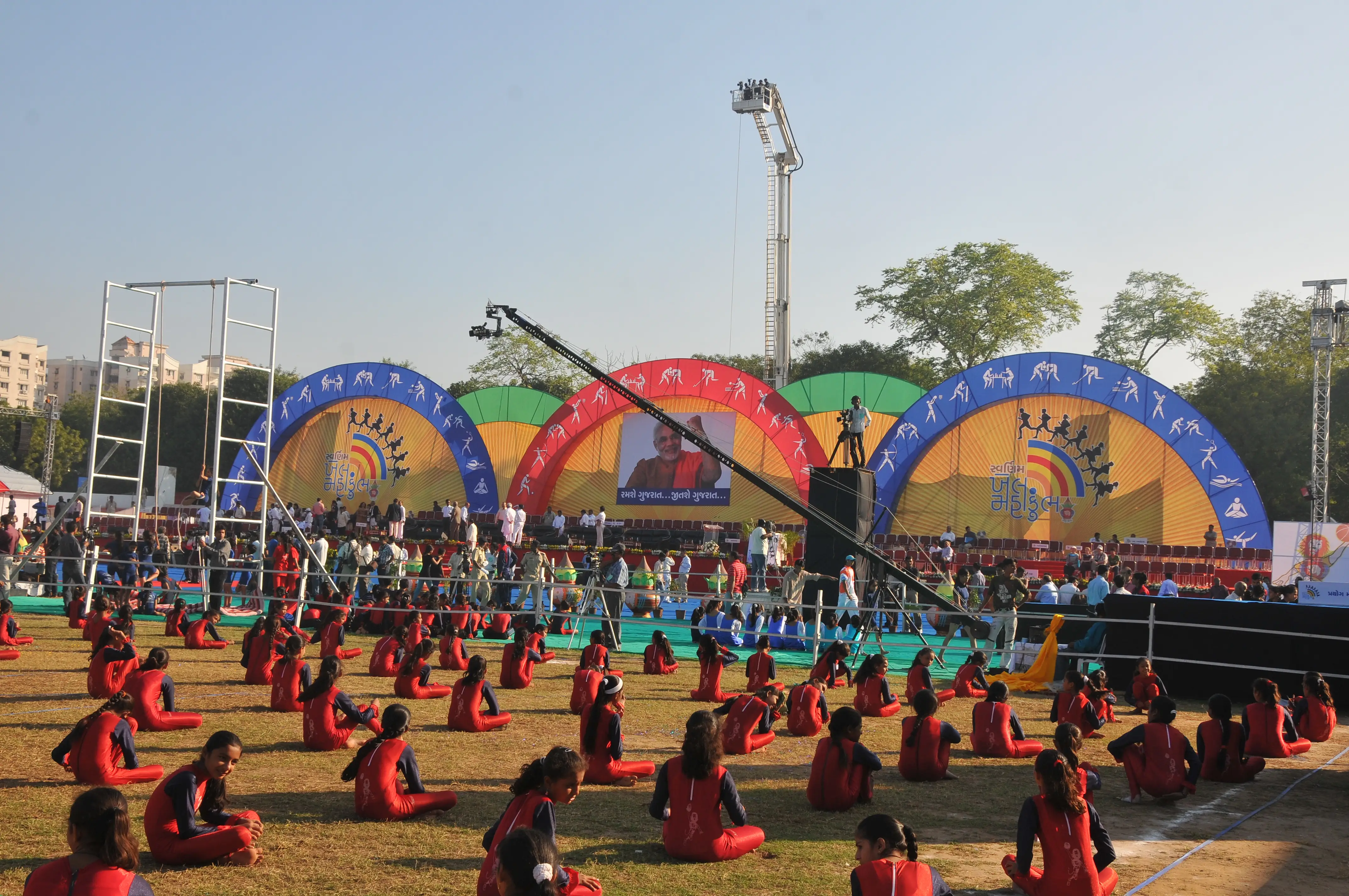 Men lighting ceremonial lamp at event with ITT banner in background