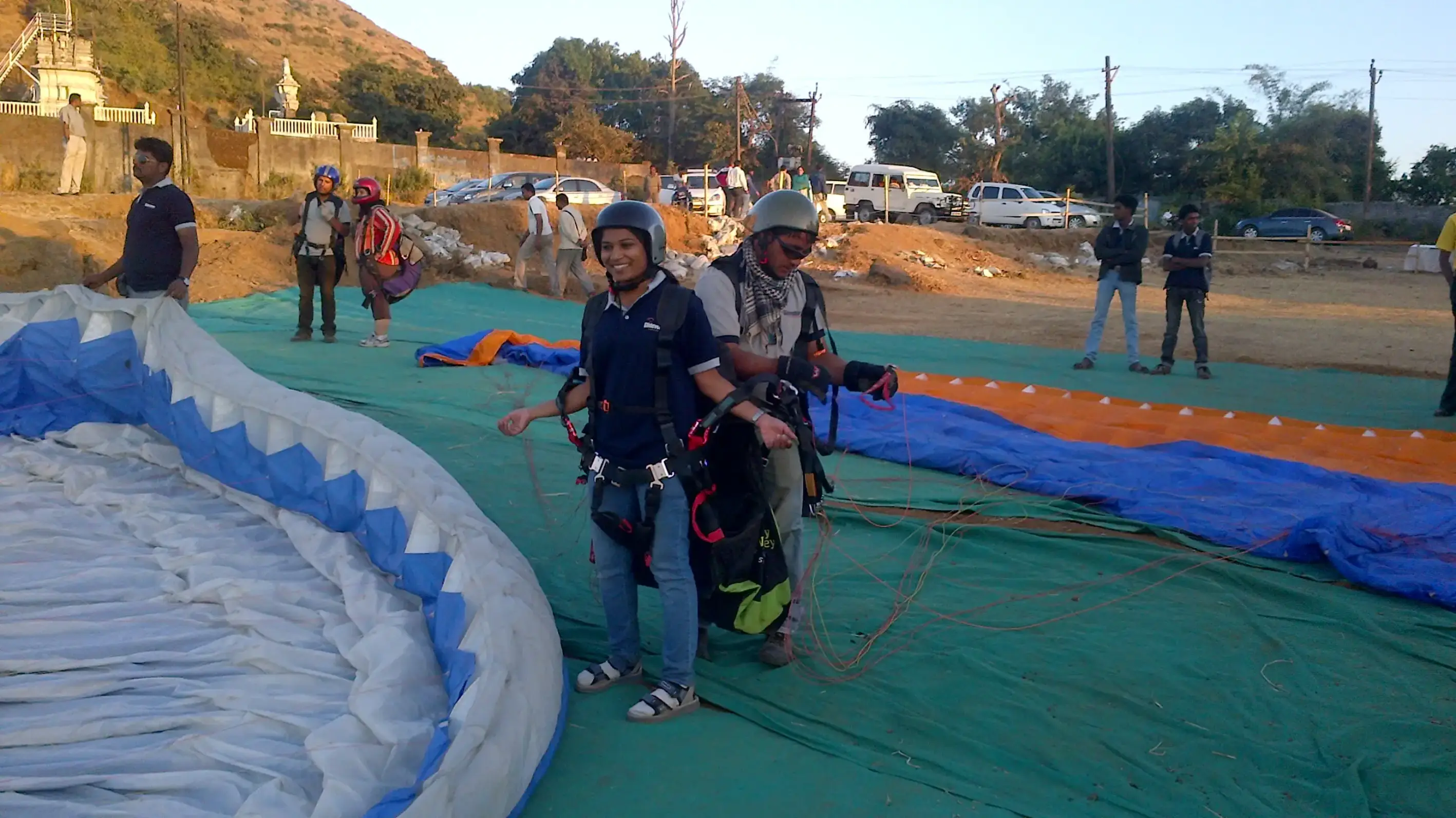 Group of men posing with large cartoon character inflatable figures at night outdoors