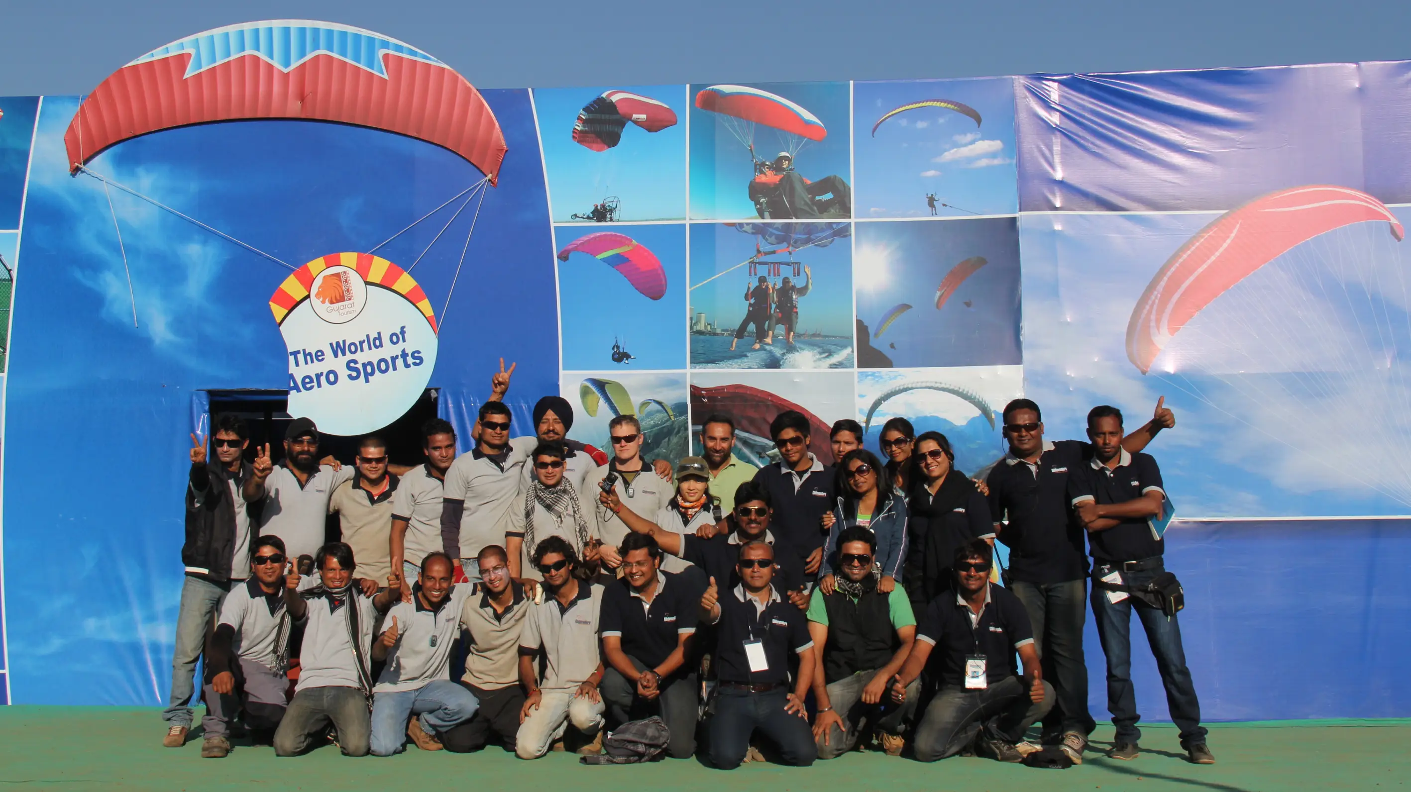 Men lighting ceremonial lamp at event with ITT banner in background