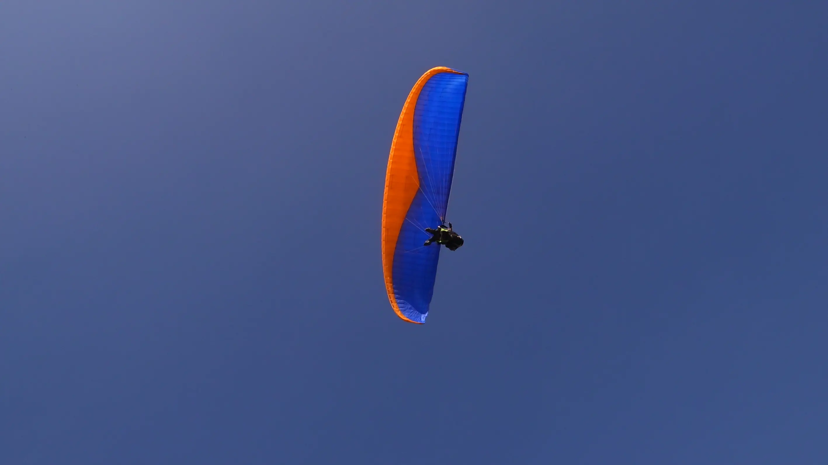 Men lighting ceremonial lamp at event with ITT banner in background