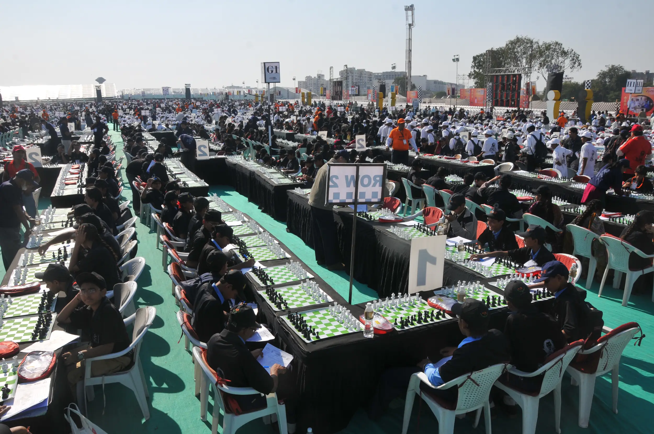 Group of men posing with large cartoon character inflatable figures at night outdoors