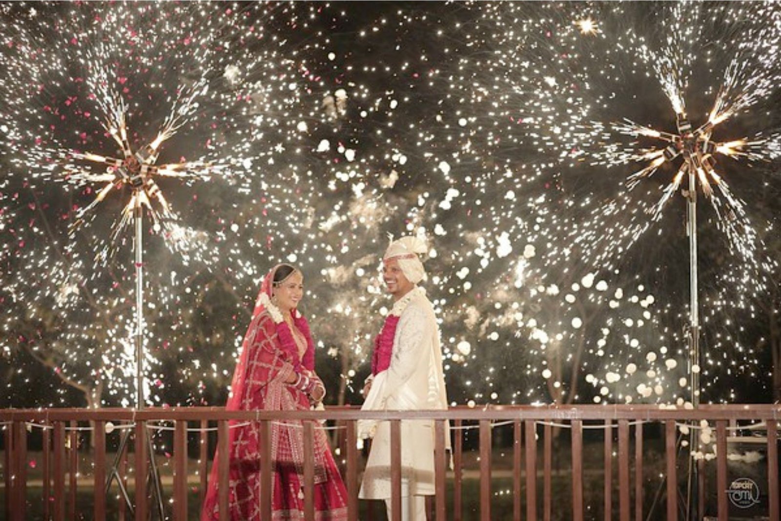 Group of men posing with large cartoon character inflatable figures at night outdoors