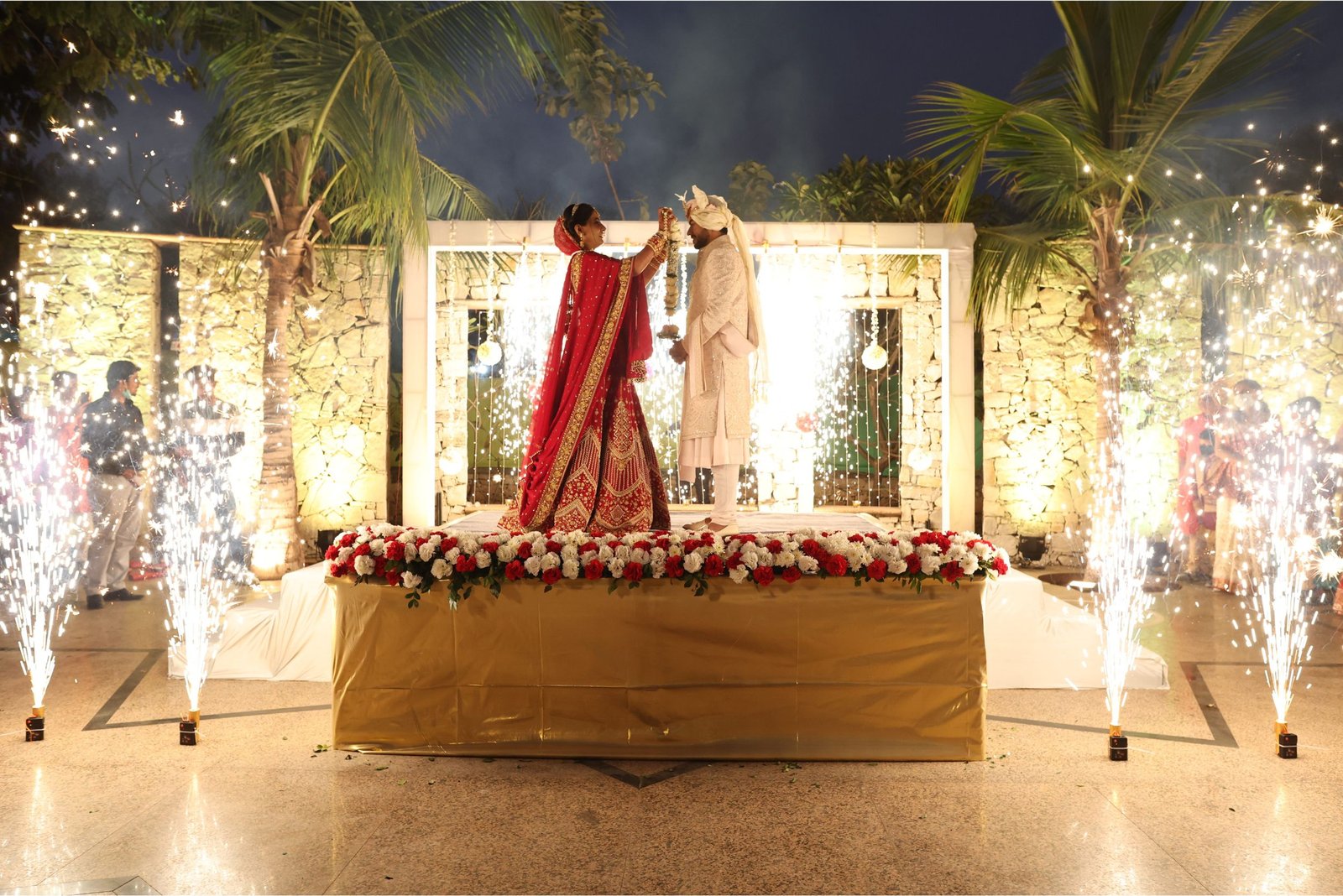 Corporate event photo with 5 people on stage in formal attire and audience in background
