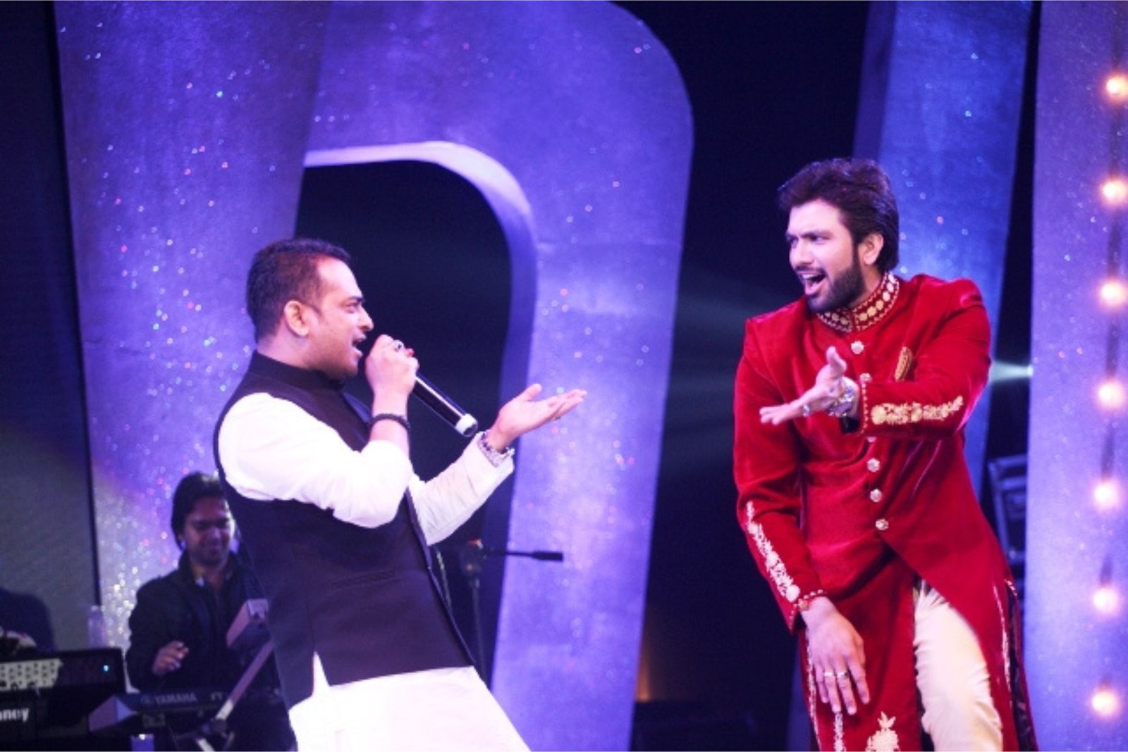Men lighting ceremonial lamp at event with ITT banner in background