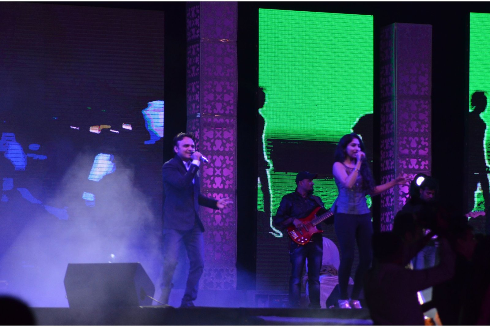 Men lighting ceremonial lamp at event with ITT banner in background