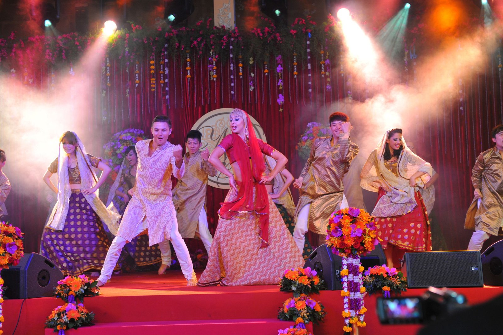 Men lighting ceremonial lamp at event with ITT banner in background